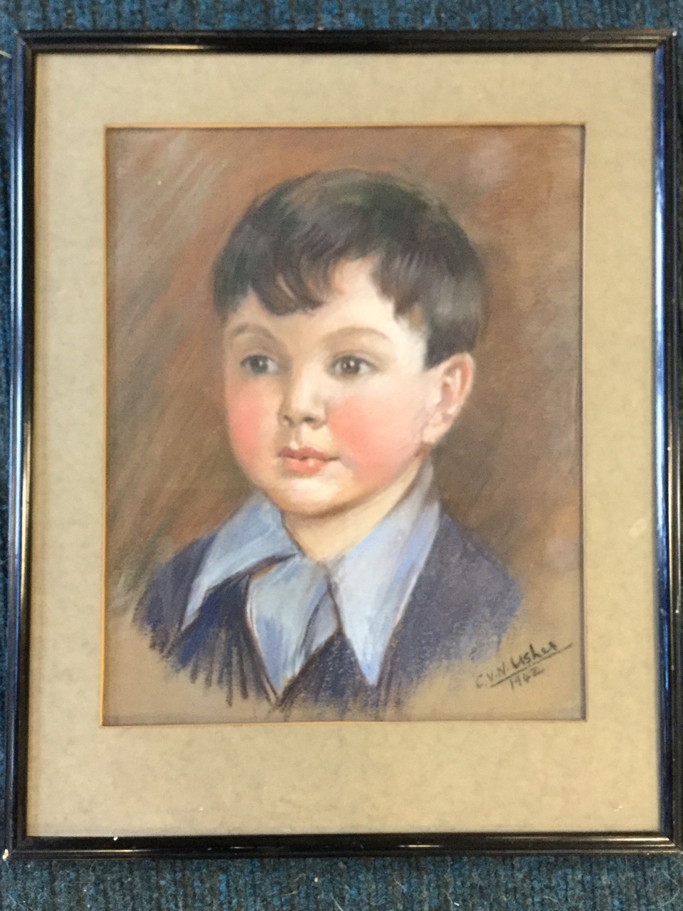 C Usher, pastel portrait of a boy, dated 1942, signed, mounted & framed. (12in x 15in)