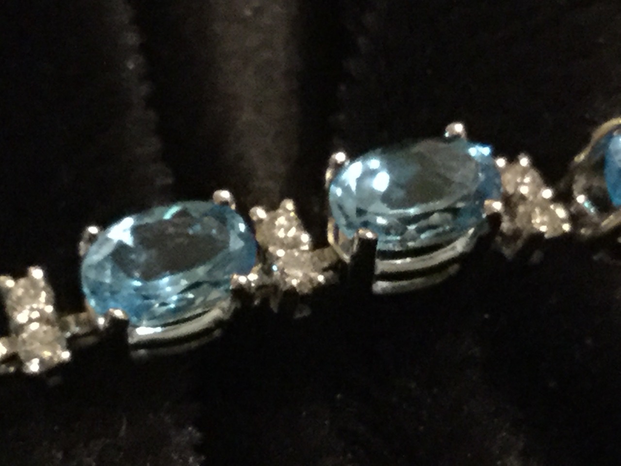 An 18ct gold blue topaz and diamond bracelet, with twenty one claw set topaz stones weighing - Image 3 of 3