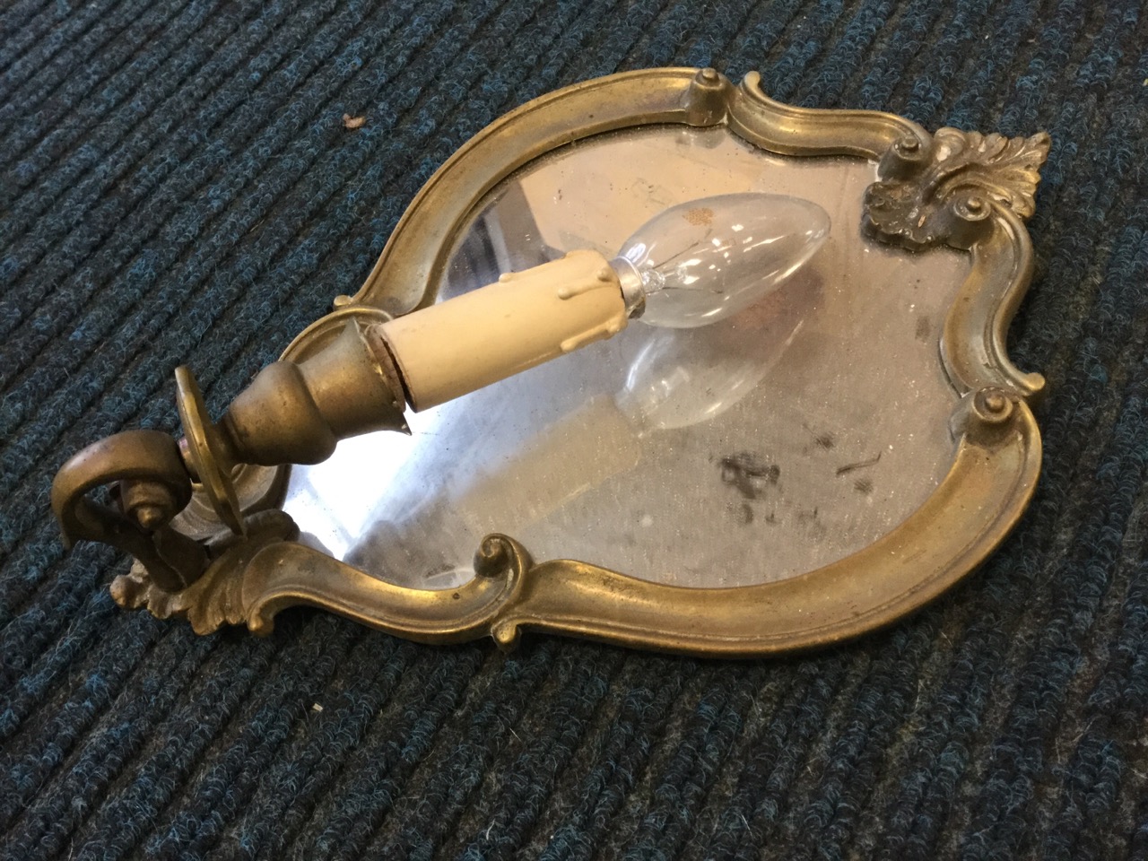 A brass wall sconce with oval bevelled mirror back and two scrolled branches holding candlelights; - Image 2 of 3