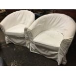 A pair of contemporary tub armchairs with loose cushions & covers, raised on tapering beech legs. (