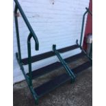 A pair of painted metal caravan steps with angled hand rails, the three three treads with grip