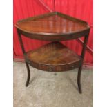 A Georgian mahogany corner washstand, the top pierced for bowls with later shelf, above a mid-tier