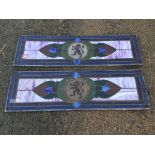 A pair of rectangular stained and leaded glass panels centering on circular red lion rampants,