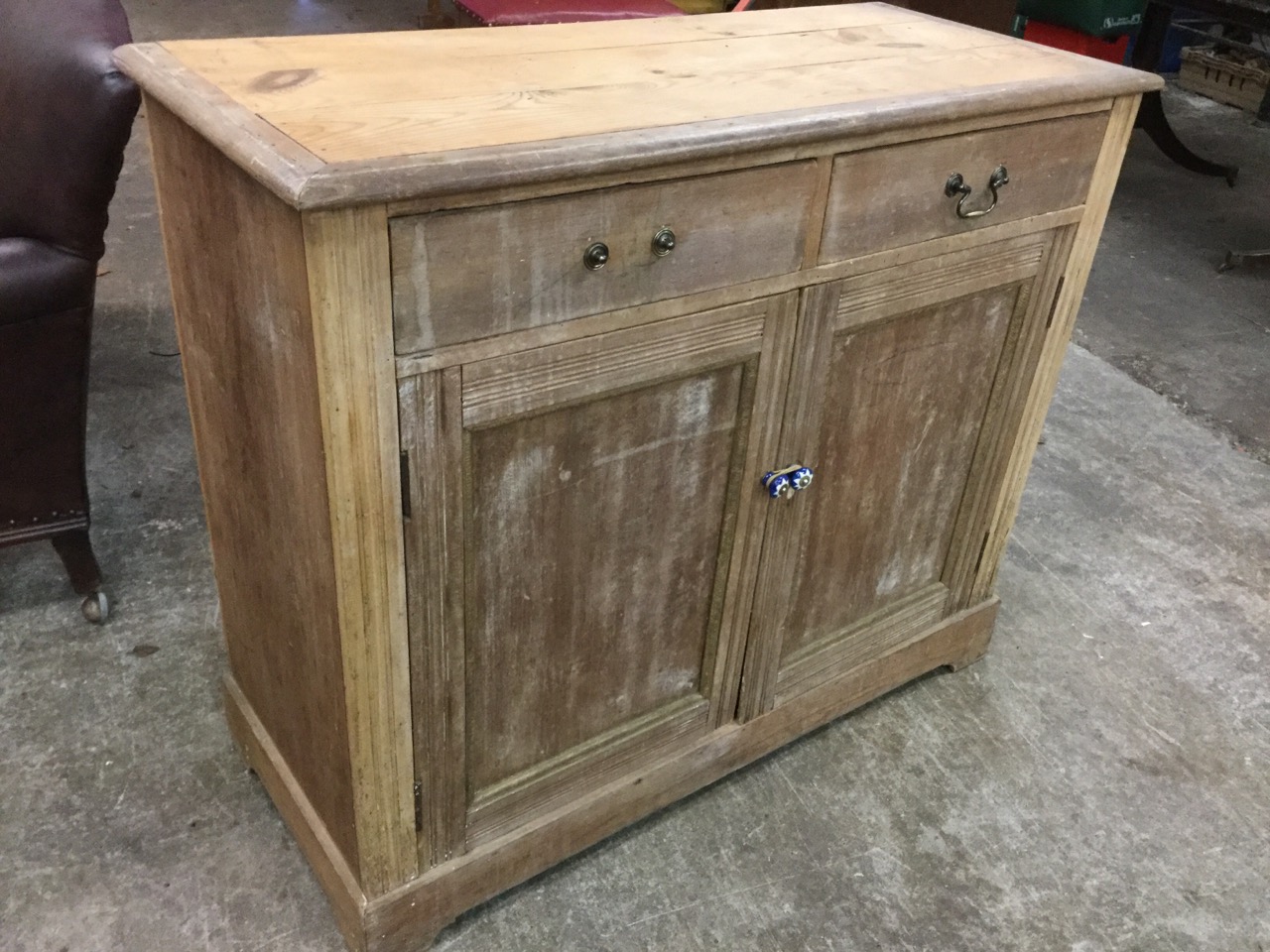 A late Victorian satin walnut cabinet with two drawers above panelled cupboards with applied press