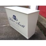 A painted shop counter, the rectangular cabinet with angled front panel supported on a plinth, the