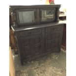 A Priory oak court cupboard, with plate rack above chisel carved frieze and leaded glass doors