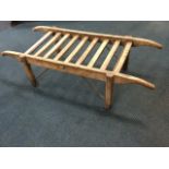 A late Victorian luggage rack or pig table, with shaped ash shafts framing rectangular slatted