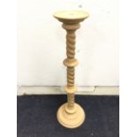 A beech jardiniere stand with circular tray top on twisted column above a moulded base. (39in)
