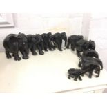 A graduated group of ten carved ebony elephants, with inlaid eyes and feet. (10)