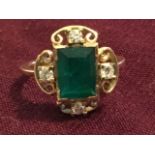 An 18ct art deco emerald ring, the Zambian cut emerald weighing two carats, framed by four