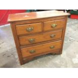 A late Victorian walnut chest of two short and two long drawers mounted with brass plate handles,