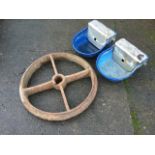 A pair of rounded animal water troughs with valve feeders; and a cast iron wheel with four