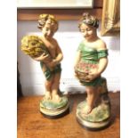 A pair of boy & girl plaster harvest children, with sheaf of corn and basket of flowers, the figures