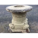 A composition stone seat or stand, cast as a leaf moulded pillar on square waisted plinth base