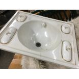 A Victorian ceramic basin, the circular bowl with dog-head waterspout, framed by four moulded soap
