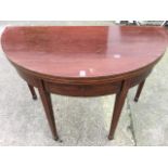 A nineteenth century 'D' shaped mahogany dining table, the boxwood strung hinged top supported on