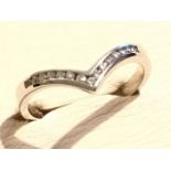 An 18ct gold diamond eternity ring, the fifteen diamonds channel set within a wishbone design, the