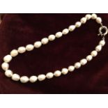A pearl necklace, with thirty-seven irregular rice shaped individually knotted pearls, mounted