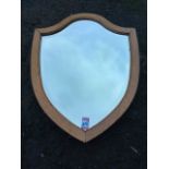 An oak framed shield shaped mirror with bevelled plate. (18.5in x 24in)