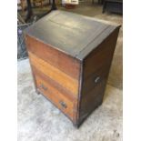 A late Victorian scumbled pine box, the boarded cabinet with sloping lid to bin above a drawer,