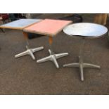 A pair of square cafe tables with formica tops on columns, supported by crossed aluminium feet;