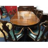 An Edwardian Queen Anne style mahogany dining room suite with ten chairs, a wind-out dining table