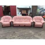 A modern stitched leather three-piece suite, with loose cushion seats on slatted frames, having