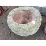 An ancient circular sandstone quern. (18.5in dia x 13in)