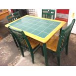 A tiled top table with rectangular beech frame supported on rounded legs, with four matching painted