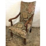 A late Victorian upholstered armchair, the rectangular padded back above shaped arms on columns, the