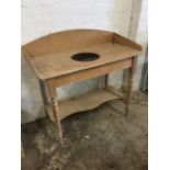 A Victorian pine washstand, the rectangular top with arched back raised on baluster turned legs