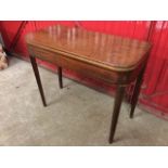 A nineteenth century turn-over-top mahogany tea table, the rounded twin-leaf top above a boxwood