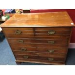 A late Victorian oak chest of drawers, with rectangular moulded top above two short and three long