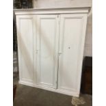 A painted Victorian pine three-door combination wardrobe, with moulded cornice above panelled