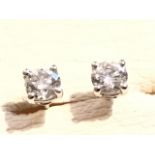 A pair of 18ct white gold diamond stud earrings, both claw set diamonds weighing just over half a