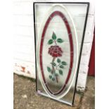 A rectangular double glazed glass panel with oval leaded glass decoration with framed floral