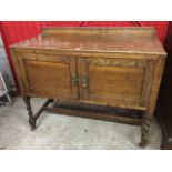 An oak washstand with applied bead & lozenge decoration to upstand, having panelled cupboard doors