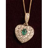 An 18ct yellow gold emerald and diamond pendant, the pear shaped emerald framed by brilliant
