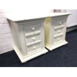 A pair of modern bedside chests, each with three moulded panelled drawers, raised on bun feet. (
