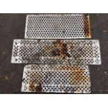 Three rectangular cast iron grill panels, with diamond and honeycomb piercings. (3)