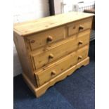 A Victorian style pine chest of drawers, the moulded top above two short and two long knobbed