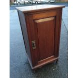 A late Victorian mahogany pot cupboard, with fielded panelled door above a shaped apron, raised on