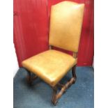 A European oak leather upholstered hall chair, having arched back above a sprung seat with brass