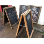 Three pine framed blackboard style A-frame notice boards, the folding hinged display boards with