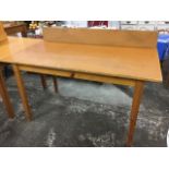 A 5ft rectangular pine table, having added upstand to one long side, raised on square tapering