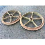 A pair of cast iron wheels, the moulded rims each with five spokes. (21in dia) (2)