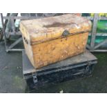 A tin trunk with rounded studded hinged lid having carrying handles to ends; and a rectangular