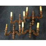 A set of four carved wall sconces, each with twin scrolled acanthus carved branches holding