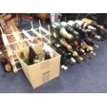 Two wine racks containing a quantity of booze - wine, champagne, spirits, beer, some opened, etc. (