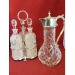 A Mappin & Webb claret jug with scrolled handle, hinged cover with pointed finial and spout